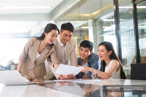 young professional asian business people working  papers  office handsome smiling