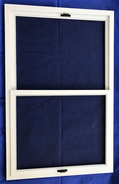 white framed windows   blue background   bottom  partially covered  black fabric
