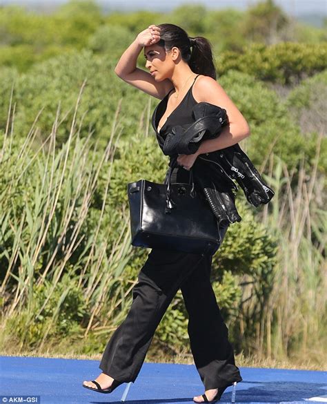kim kardashian dons plunging black jumpsuit for helicopter ride to new
