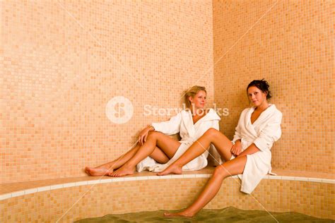 relax bath spa two beautiful women bathrobe sitting water jacuzzi