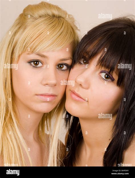 Close Up Portrait Of Two Beautiful Girls With Opposite Hair Color