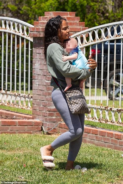 christina milian is every inch the adoring mother as she tenderly holds
