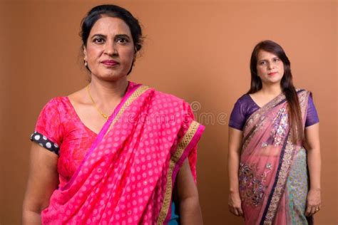 portrait of two mature indian woman wearing traditional clothes stock