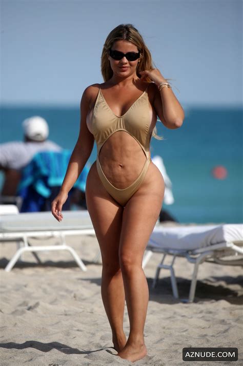 anastasia kvitko sexy in a gold swimsuit with thong bottoms at the