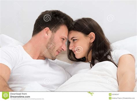 Cute Loving Couple Lying In Bed Looking At Each Stock Image