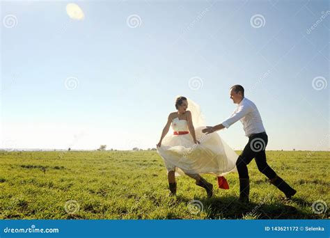 wedding couple   fun outdoor catch     stock photo image  catch happy
