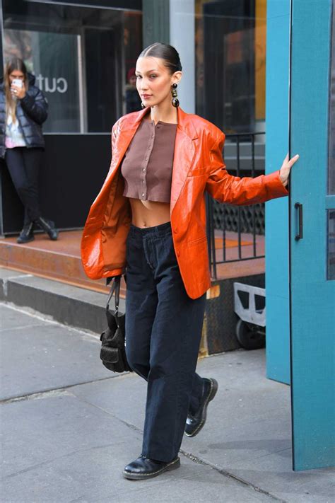 bella hadid in an orange leather blazer leaves michael kors fashion