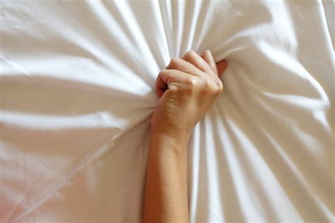 Hand Of Women Pulling White Sheets In Ecstasy Orgasm The Optimist