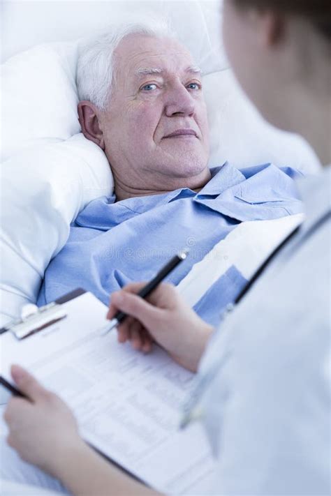 nurse interviewing elderly patient stock photo image   clinic