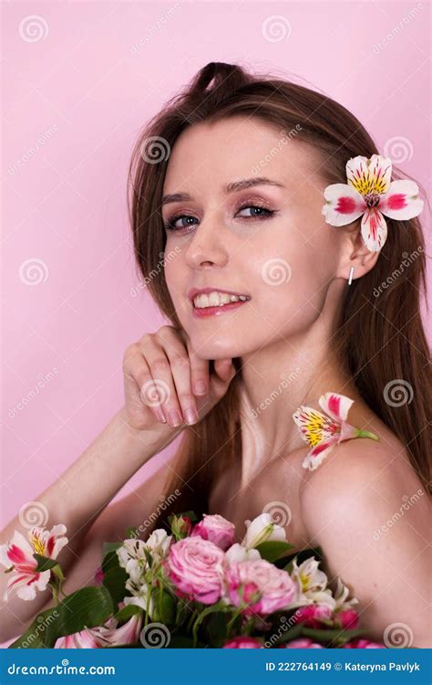 Naked Skinny Girl Holding Flowers On A Pink Background Brunette Stock