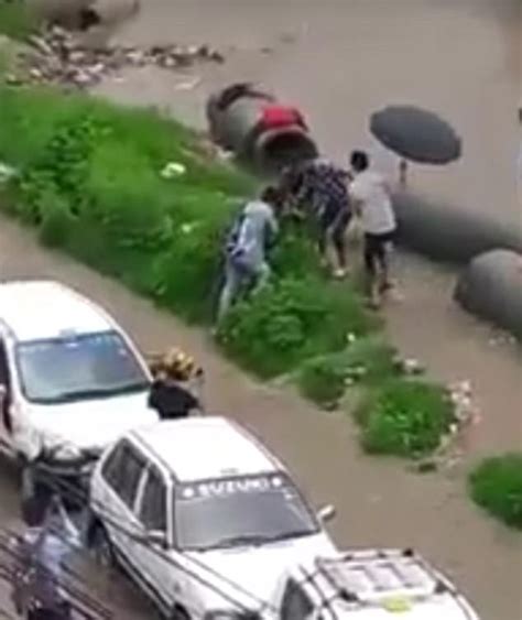 horrifying moment girl falls into an open drain in nepal daily mail online
