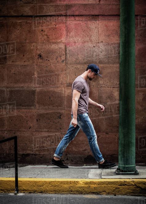 man walking   sidewalk   wall stock photo dissolve