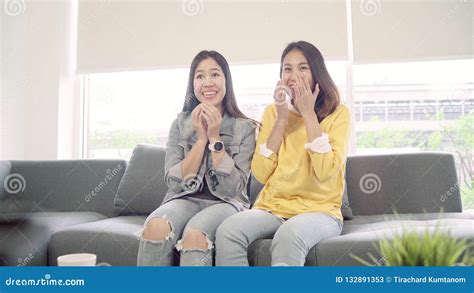 Lesbian Asian Couple Watching Tv Laugh In Living Room At Home Sweet