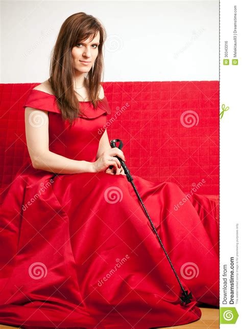 Woman Holding A Riding Crop Royalty Free Stock Image