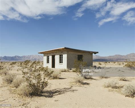 a small abandoned building in the mojave desert landscape high res
