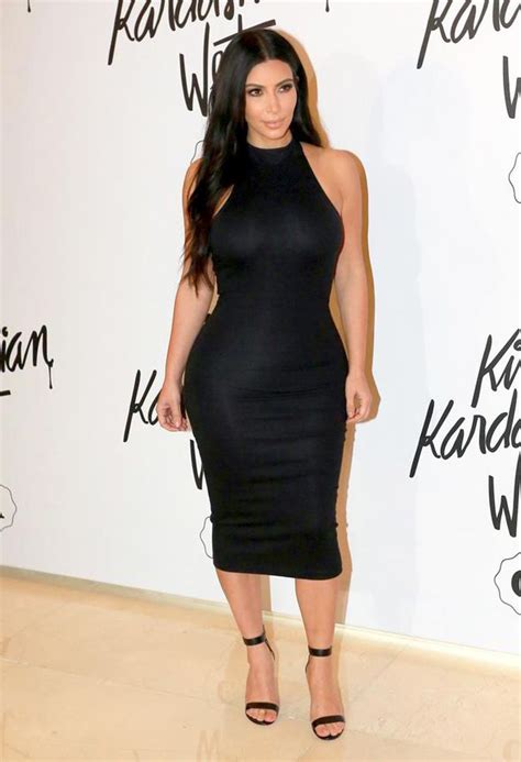 Kim Kardashian Pours Her Famous Curves Into Skintight Black Dress In