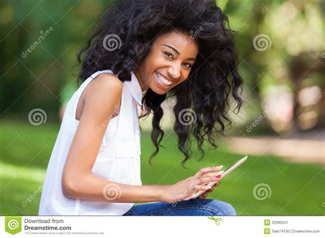 outdoor portrait of a teenage black girl using a tactile tablet stock image image of african