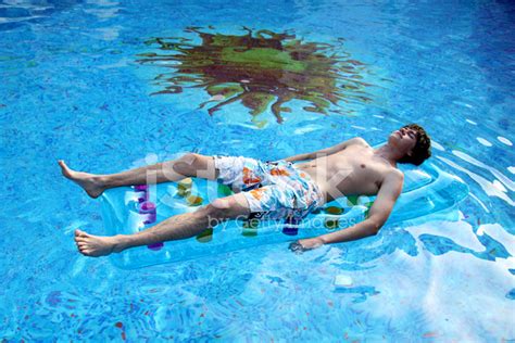 young man floats  pool stock  freeimagescom