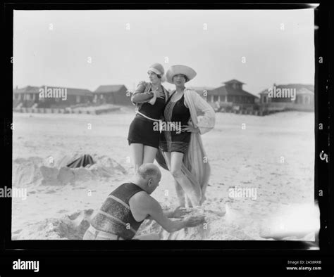 Unidentified Man Building Sand Castle And Two Women Long Beach New