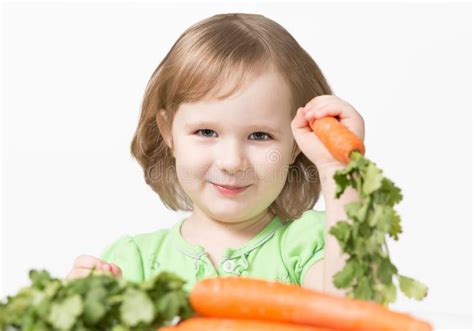 smiling child eating  carrot stock photo image  beauty green