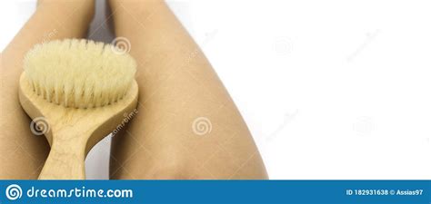 woman legs on the right side with wooden soft massage brush for body