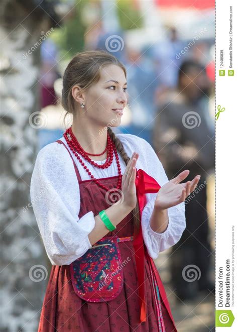 Beautiful Russian Girl In A Folk Sundress Claps Her Hands