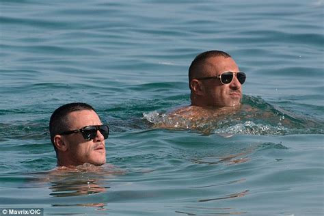 Shirtless Luke Evans Hits The Beach With Male Companion In