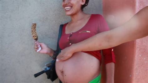 pregnant street big belly eating a chocolate covered