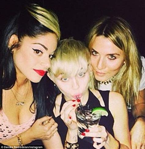 miley cyrus buries her head into amazon ashley s cleavage daily mail online