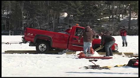 crews work  retrieve truck  broke  ice  lake