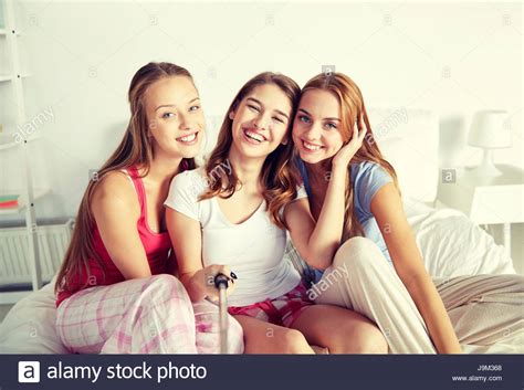 Teen Girls With Selfie Stick Photographing At Home Stock