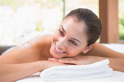 Beautiful Smiling Brunette Lying On Massage Table With Salt Scrub On