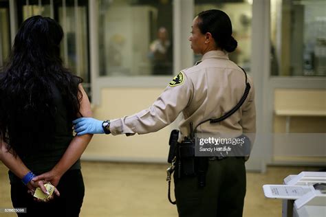 a female sheriff s deputy prepares to move an inmate to her jail cell