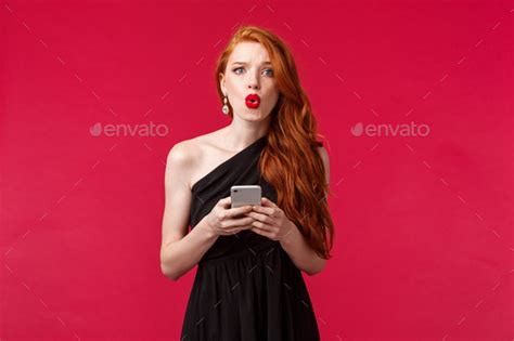 Portrait Of Concerned And Confused Young Redhead Woman Being Dumped By