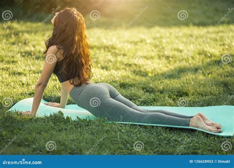 woman practicing yoga outdoors in park stock image image of calmness