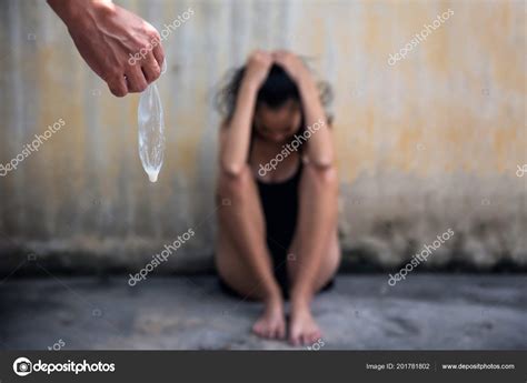 man hand holding used condom white semen sperm while