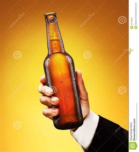 bottle  beer   man  hand stock image image  beer yellow