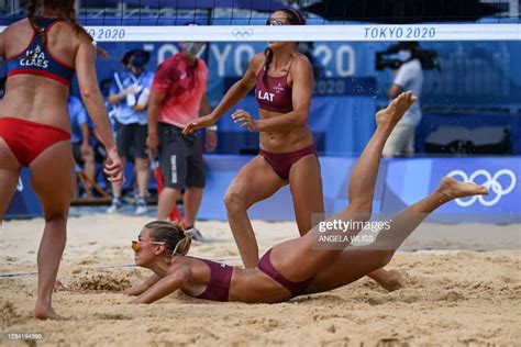 latvia s tina graudina falls in the sand in their women s preliminary