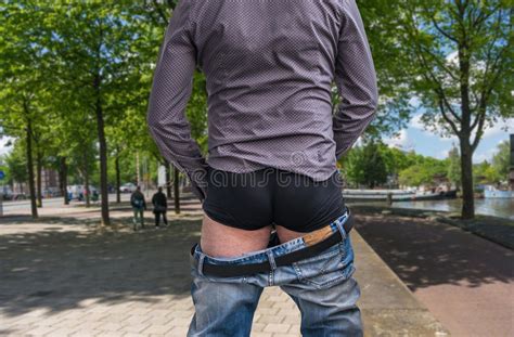 Standing Man Peeing To A Street In Big Town Stock Image