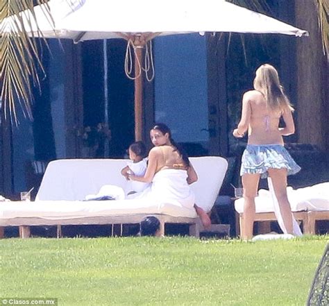 kim kardashian sunbathes in yellow bikini while her nanny