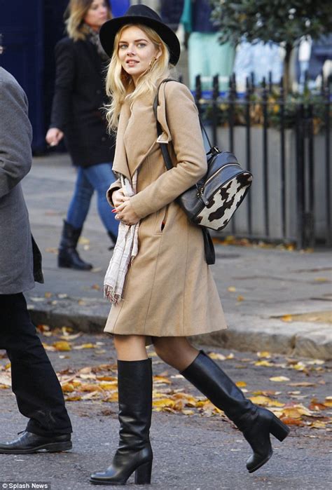 samara weaving rugs up in a trench coat and knee high