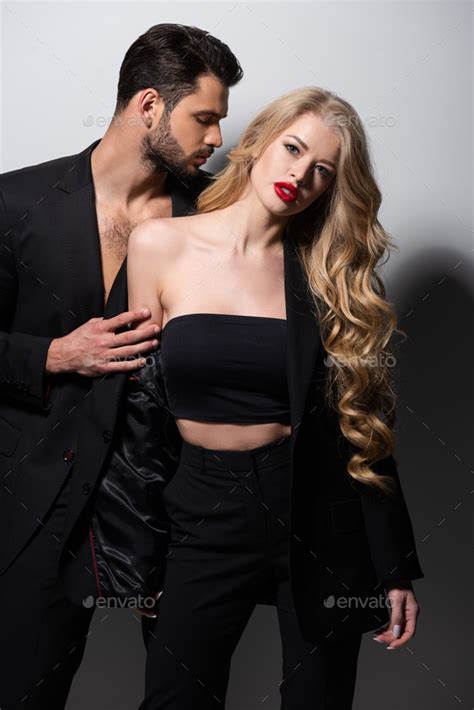 Bearded Man Undressing Attractive Girlfriend With Red Lips On White