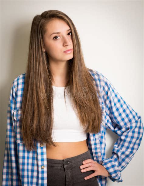 beautiful teen girl in a white top and blue shirt stock