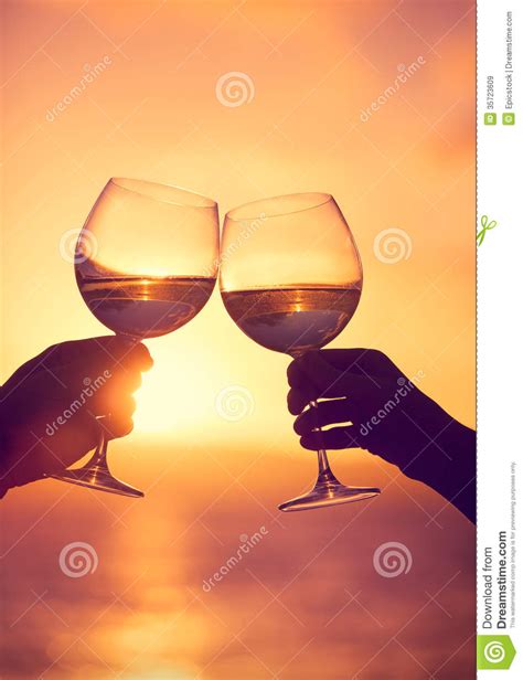 Man And Woman Clanging Wine Glasses With Champagne At