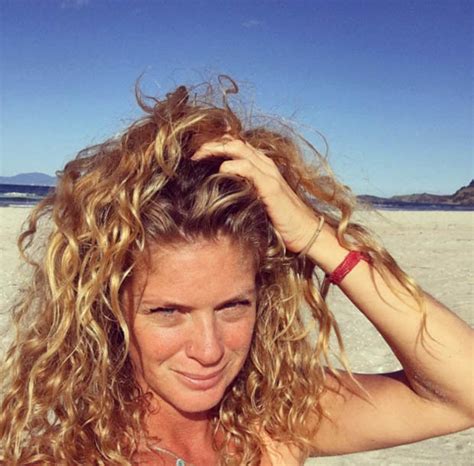 rachel hunter 47 writhes in sand in sultry two piece