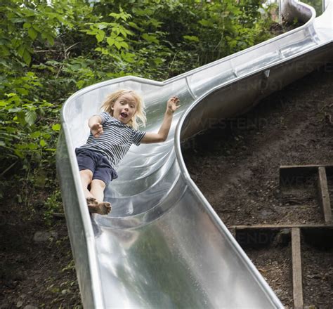 boy sliding  playground  stock photo