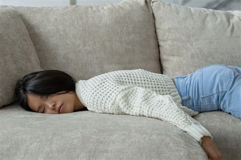 Premium Photo Exhausted Young Asian Woman Falls On The Sofa A Tired