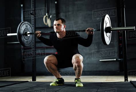 active man lifting weight  workout  gym stock photo dissolve
