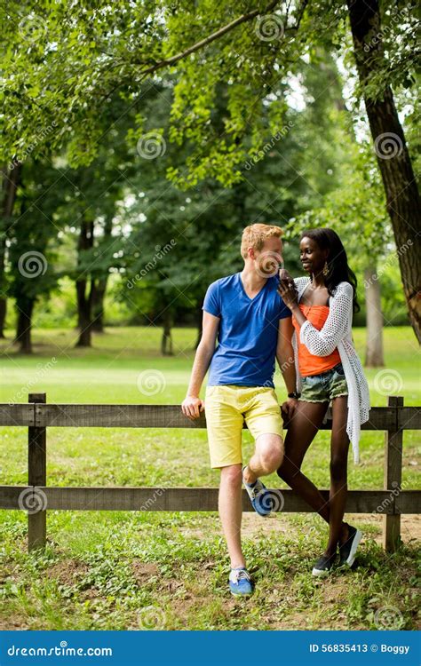 Multiracial Couple In The Park Stock Image Image Of Casual Sitting