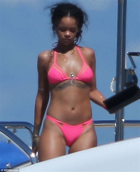 thinking pink rihanna shows off her stunning figure in a bright bikini as she sunned hers